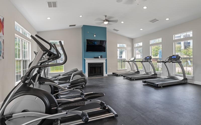 a room with treadmills and a tv