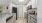 Kitchen with granite countertops, white cabinetry and stainless steel appliances