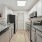 Kitchen with granite countertops, white cabinetry and stainless steel appliances