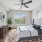 a bedroom with a bed and a fan