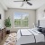 a bedroom with a bed and a fan