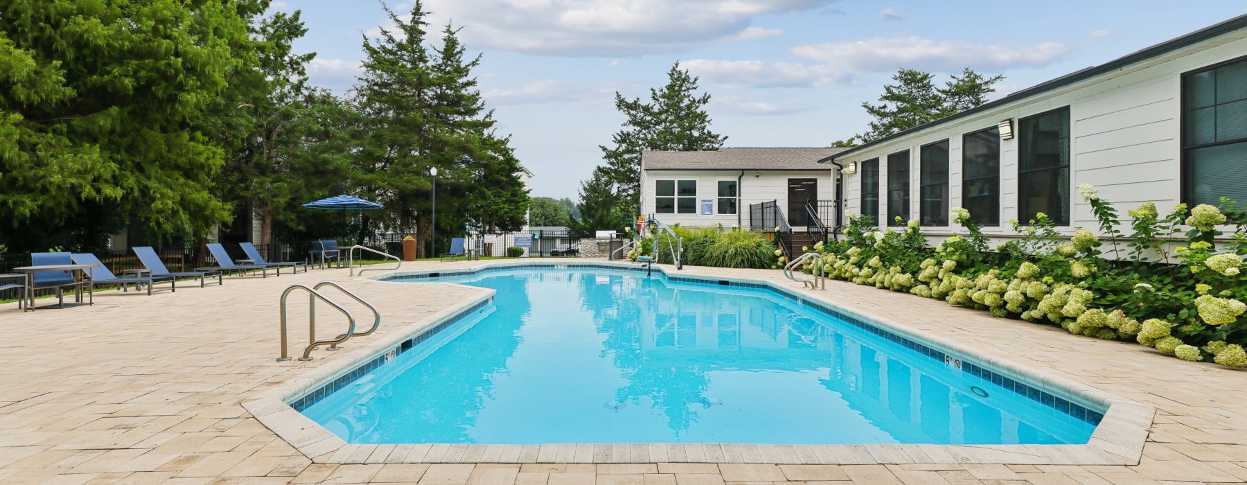 Pool with expansive sundeck and pool chairs